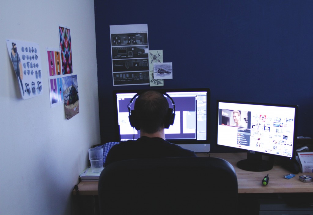 Jarman lead illustrator working on computer with headphones on