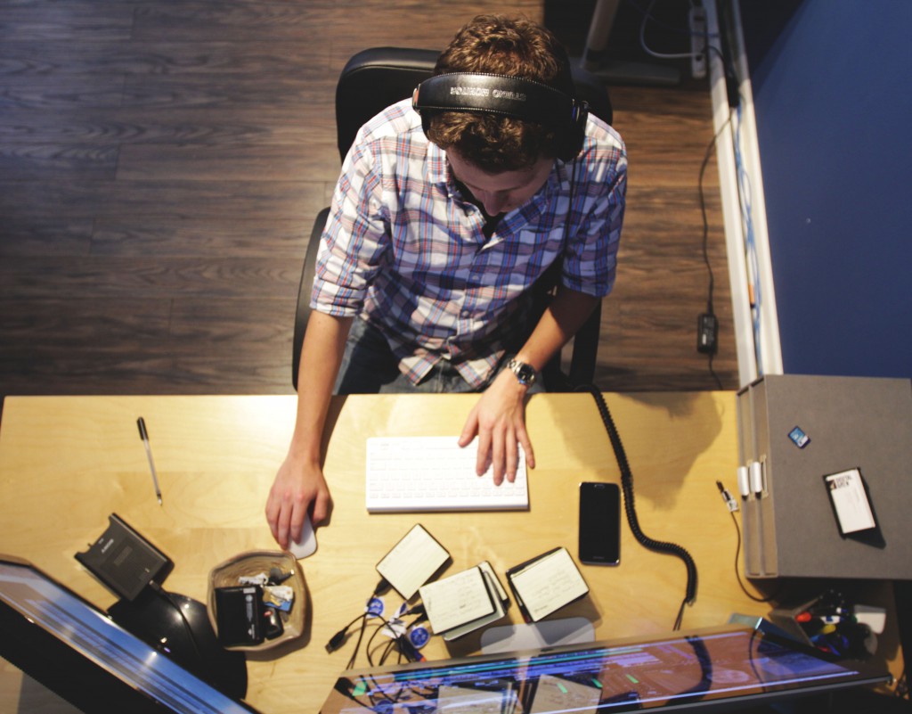 over head shot of senior editor editing videos on computer 