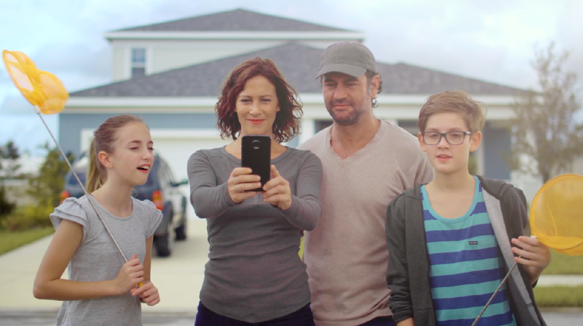 family standing in front of house
